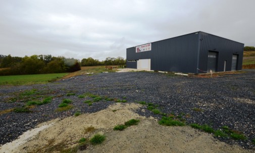 Commercial premises, industrial garage and workshop, house, land and HGV carpark. New buildings and carpark. On the N124 road axis. Investment potential.